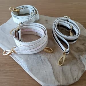 Bandoulières, anses réglables pour sac . Différents coloris et motifs. Bouclerie dorée.