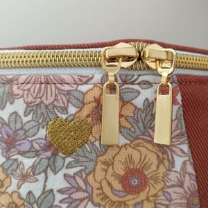 Sac banane Les Fleuris. Couleur Sienne et empiècement fleuri. Détail sur la broderie et la fermeture.