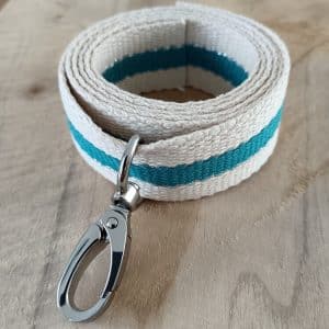 Bandoulières, anses réglables. Coloris : beige, turquoise, liserés dorés Bouclerie argentée.
