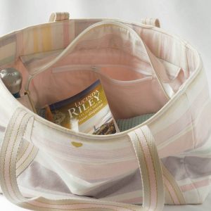 Sac cabas en polyester et coton recyclés, de couleurs pastels (rose, jaune, violet, vert d'eau), avec fermeture par zip. Vue sur la doublure et la poche intérieure zippée.